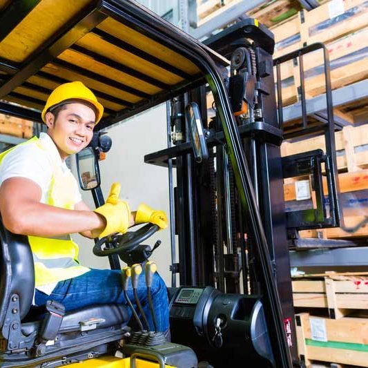 Man operating a forklift giving a thumbs up
